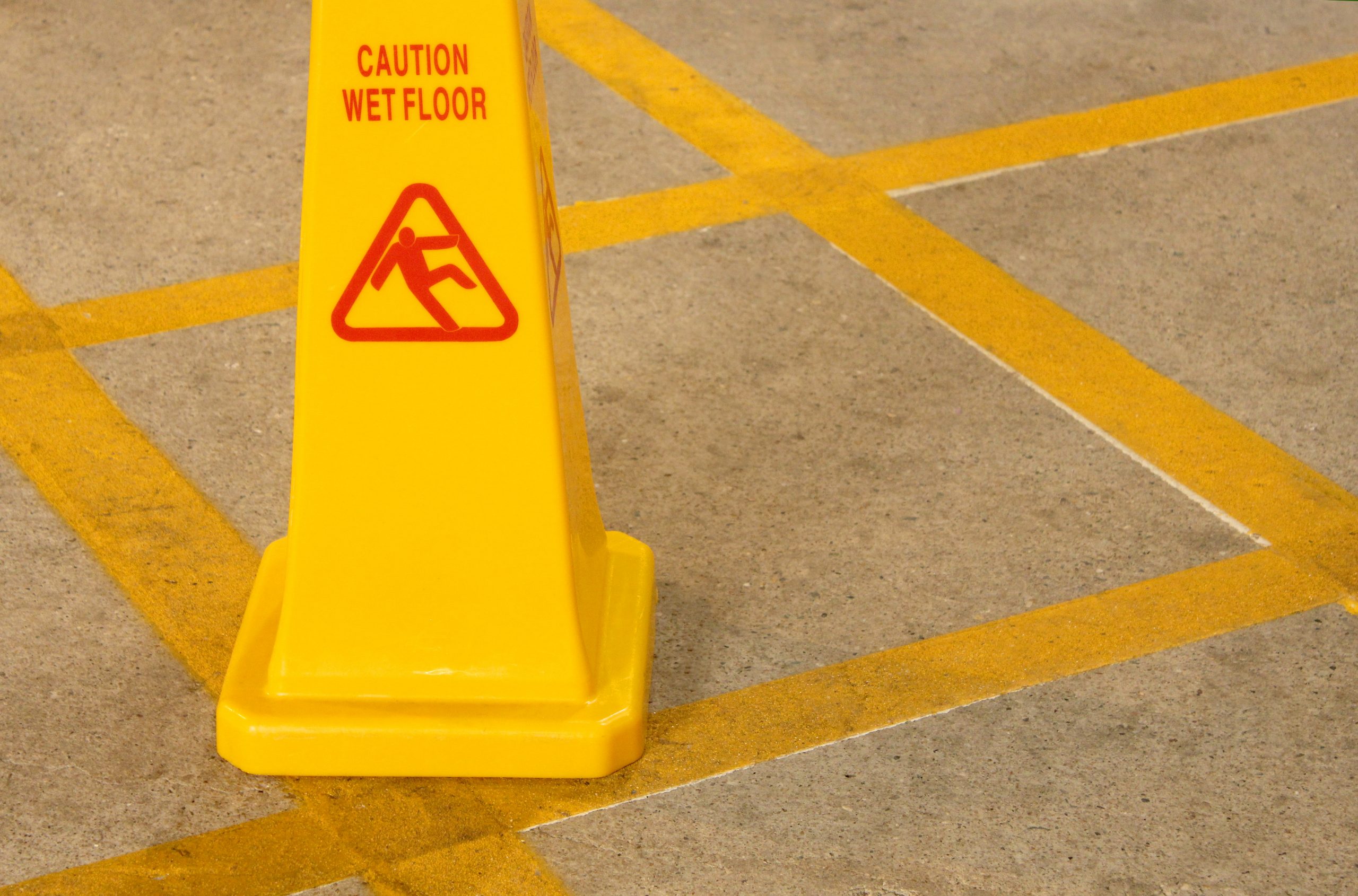 yellow caution sign for wet floor